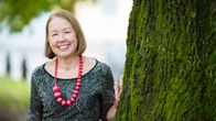 Alavuden kaupunginjohtaja Liisa Heinämäki nojaa puuhun.