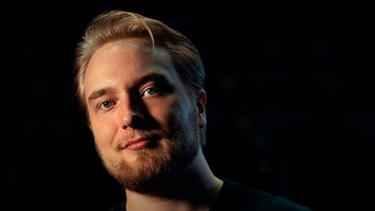 A man looks in the camera. On top of the image the text “At yle, I get to follow the latest technological developments from a front-row seat. It’s inspiring to work with the latest tools and aso be involved in their development.”