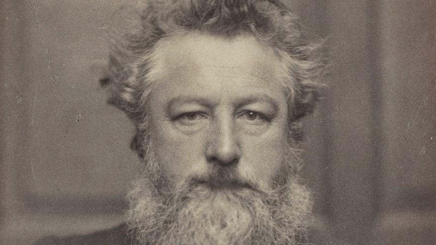 Mustavalkoinen valokuva muodollisesti pukeutuneesta parrakkaasta miehestä 1800-luvun loppupuolelta.