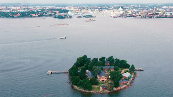 Aerial photo of Helsinki Harbour, with a small island dotted with old houses in the foreground,