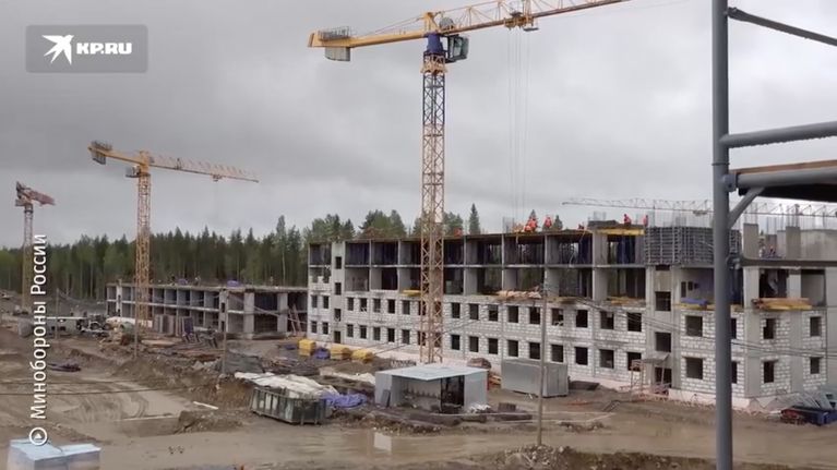 Three large cranes at a garrison construction site. 