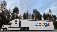Long white lorry with Google printed in big colourful letters on the side of the truck.