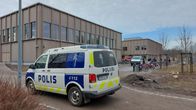 Two police vans outside a school.
