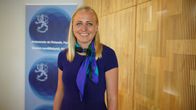 Foreign Minister Elina Valtonen looks straight into the camera with a smile.