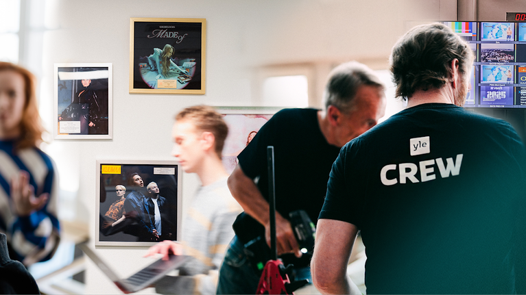 Image showing many Yle employees, for example editors filming, scenography workers at work and a person in the control room.