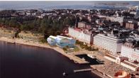 En digital bild på en byggnad med två stora liggande strutar vid en stadskaj.