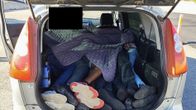 Legs visible in the back of a car.