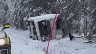 Valkoinen Saaga Travelin linja-auto kaatuneena kyljelleen. 