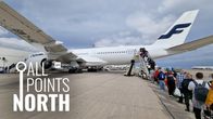 Photo shows a queue of people waiting to board a Finnair aircraft at Las Palmas airport.