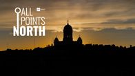 The silhouetted Helsinki Lutheran Cathedral against the sunset.