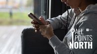 Photo shows a woman holding a phone.