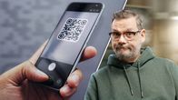 Henkilö pitää älypuhelinta, jonka näytöllä on QR-koodi; oikealla mies vihreässä hupparissa katsoo kameraan.
