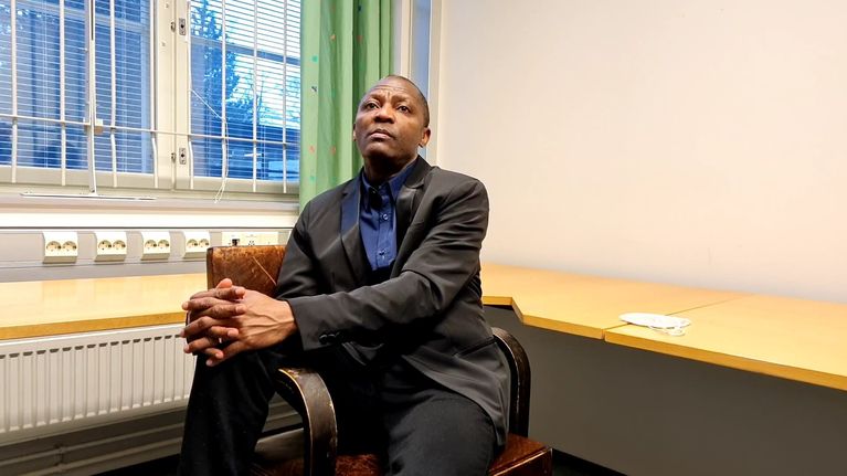 Gibril Massaquoi sitting on a chair.
