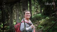 psykologi Liisa Uusitalo-Arola metsäretkellä reppu selässä iloisen näköisenä