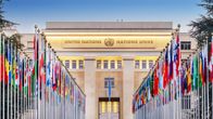 Ingången till Nationernas palats i Genève. FN:s medlemsländers flaggor i förgrunden.