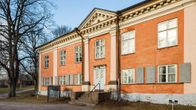 Kulosaaren kartanon julkisivussa on toistakymmentä suurta ikkunaa. Pääsisäänkäyntiä reunustavat koristepylväät.