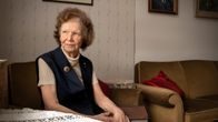 Lähes 90-vuotias Pirkko Kauppinen istuu sukunsa kirjakaupassa nojatuolissa ja katsoo ikkunasta ulos.