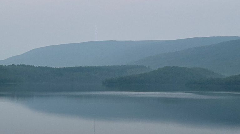 Utsjoen Mantojärvi ja Ailigas-tunturi pienen savuverhon takana. 