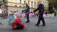 Helsinki police officers pepper spraying environmental protesters in the face during a demonstration in Helsinki in October 2020.