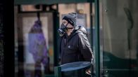 Hengityssuojainta käyttävä mies kadulla