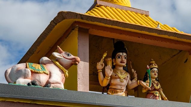 Colorful figures on a temple roof.