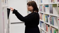 Sosiaalityön opiskelija Viivi Linna Itä-Suomen yliopiston kirjastossa.