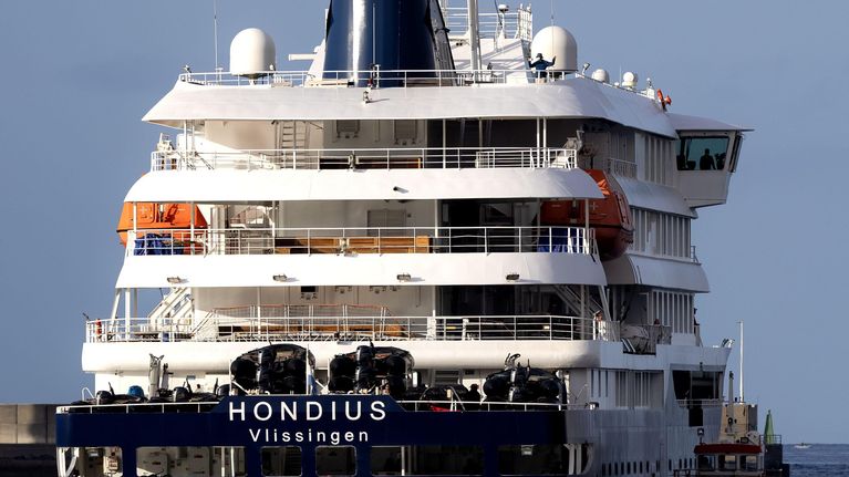A large, white cruise ship at sea.