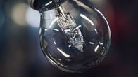 Close up photo of a clear glass LED light bulb.