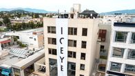 An office building with an Iceye banner running down its front. 