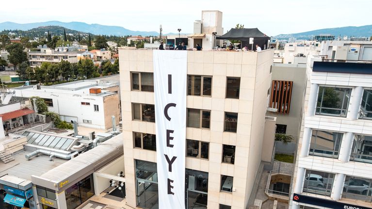 An office building with an Iceye banner running down its front. 
