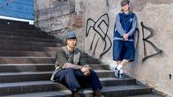 Kaksi henkilöä poseeraa portaissa. Taustalla betoniseinä, jossa graffiteja. He ovat pukeutuneet japanilaisesta muodista inspiroituneisiin vaatteisiin.