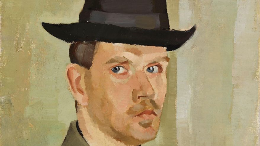 Viiksekäs mies hattu päässä.