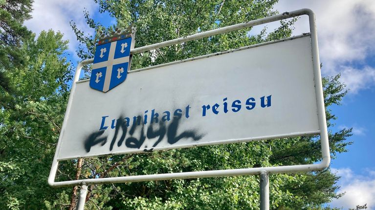 Kyltti, jossa lukee Luanikas reissu. Kyltissä on myös Rauman vaakuna ja mustalla sprayjattu suttu.