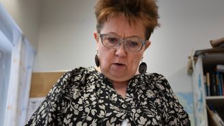 Tarja Huuskonen selaa vauhdilla vanhaa mappia toimistossa.
