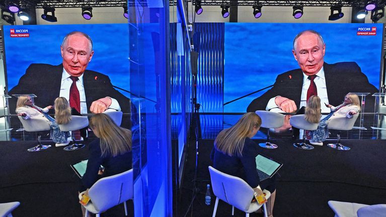 Vladimir Putin on a giant screen at a conference. 