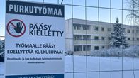 Kyltti metalliaidassa. Kyltissä lukee: purkutyömaa, pääsy kielletty. Taustalla näkyy vanha, betonirakenteinen, kolmikerroksinen kerrostalorakennus. 