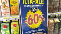 A sale sticker on a refrigerated store shelf advertising 60 percent off. 