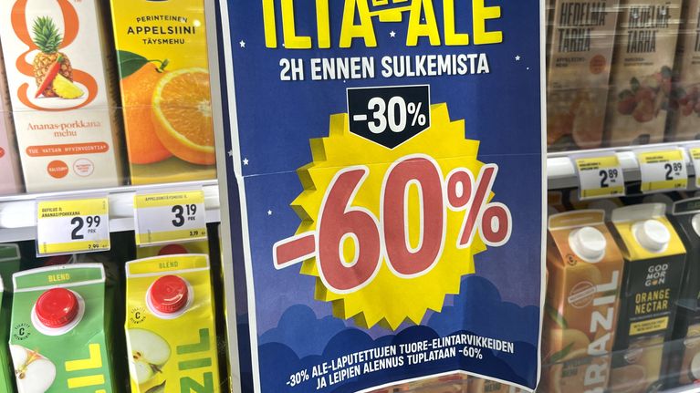 A sale sticker on a refrigerated store shelf advertising 60 percent off. 