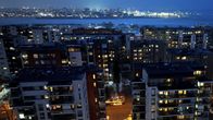 Apartment buildings pictured against the darkening evening sky. 