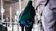 The picture shows a woman wearing a head scarf in the centre of Helsinki in August 2020.