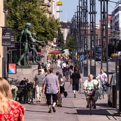 Photo shows people on a street in Tampere.