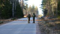 Photo shows two soldiers at the site of a drone find.
