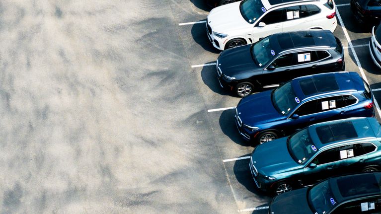 Uusia autoja rivissä parkkipaikalla.
