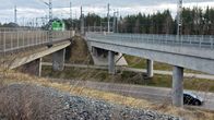 Sähköveturi ylittää sillan, kun auto kulkee alittavalla tiellä.