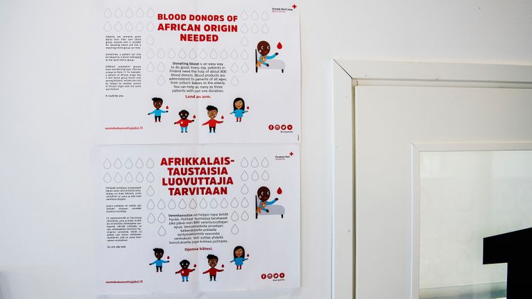 Poster on a wall saying "BLOOD DONORS OF AFRICAN ORIGIN NEEDED"