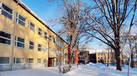 Gula och röda byggnader som är Yrkeshögskolan Novia i Ekenäs. Det är vinter med snö.
