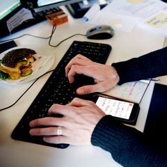 A person sitting in front of a laptop.