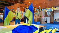 Photo shows two women with Ukrainian flags.