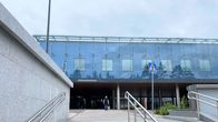 Lähikuvassa on Päijät-Hämeen keskussairaalan sisäänkäynti ja siihen johtavat portaat. Ihminen kävelee kohti sairaalaa.