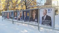 A row of presidential campaign posters, featuring each candidate, along a snowy pavement in Jyväskylä.